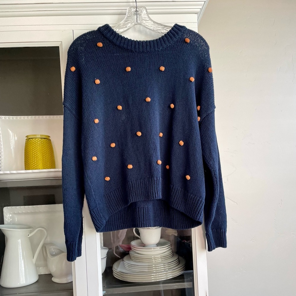 Madewell knit navy blue sweater with orange Pom Pom balls. Size medium